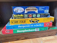 Stack of five game boxes on shelf