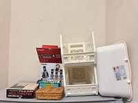 Group shot of all items: VTech phone box, Micronta multimeter box, Guard accessory, wicker basket, plastic storage baskets, wash basin