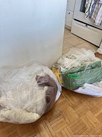 Two large clear bags filled with assorted linens