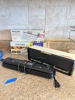 Group shot of both sealing machines with Philips bags and Seal-A-Meal rolls