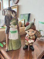 Both ceramic figurines side by side on table