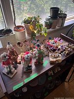 Full shelf showing stone and glass clown figurines