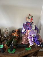 Group shot of four clown figurines on table
