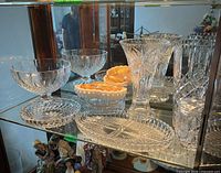 Shelf with two crystal bowls, two vases, ashtray, candy dish, platters