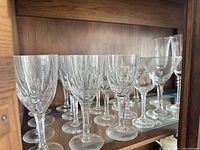 Front view of assorted crystal glasses on shelf