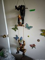 Full view of two-clown hanging wall sculpture on wall