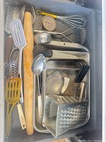 Drawer view showing variety of utensils and pans