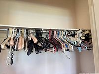 Closet rod with assorted plastic, flocked, padded, and clip hangers