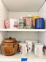 Cabinet shelves showing entire lot of drinkware and teapot