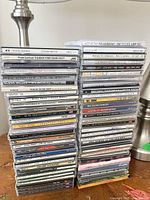 Two vertical stacks of assorted CD jewel cases