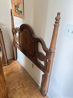Full view of wood queen headboard with posts