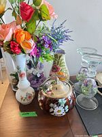Group shot of amber jar, three vases, two candle holders
