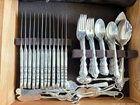 Drawer view showing knives, forks, spoons, serving utensils