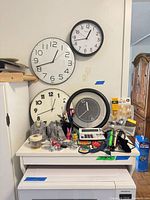 Overview showing clocks on wall and desktop items below