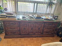Full front view of dresser loaded with items on top