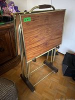 Two folding tables stacked on metal stand