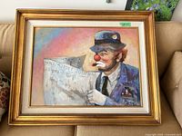 Full view of framed clown painting on sofa