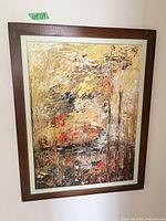 Full view of framed abstract painting on wall
