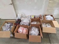 All cardboard boxes and clear bins filled with keyboard parts