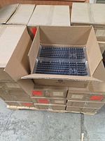 Pallet with stacked sealed Hexgears cartons, one open showing inner packaging
