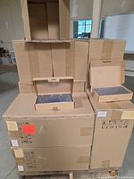 Front view of pallet with stacked master cartons and two display boxes of keycap sets opened on top.
