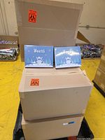 Stack of three sealed master cartons on pallet with two sample GMK Yeeti retail boxes on top