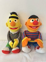 Front view of Bert and Ernie plush toys sitting upright