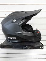 Left side view of matte black AFX NPX helmet with visor and NPX logo visible