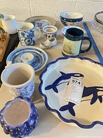 Group view of assorted blue and white dinnerware pieces on table