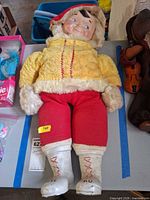 Full view of doll showing clothing and overall condition