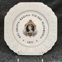 Front view of decorative plate showing portrait, inscription, embossed border