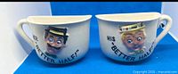 Pair of half mugs side by side forming full mug