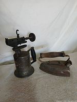 Blowtorch and iron side by side