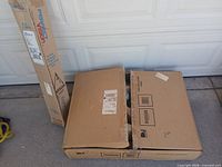 DirecTV ODU box and Perfect Vision tripod box on floor