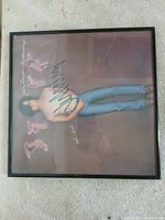 Front view of framed signed album cover