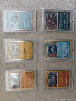 Front view of all six Pokémon cards in individual magnetic hard cases