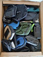 Top view of cardboard box showing assorted pouches and holsters