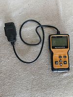 Full view of Motopower MP60933 scanner and attached OBD2 cable