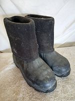 Pair of boots angled view showing rubber lower and felt upper