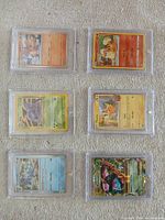 All six Pokémon cards displayed in magnetic cases