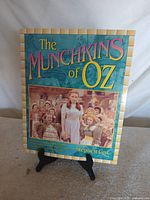 Front cover of signed book on stand
