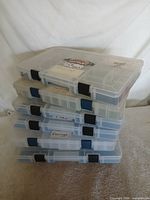 Front view showing stack of six Plano clear organizer boxes