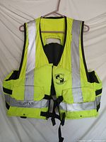 Front view of Stearns high-vis life vest showing pockets, reflective tape and name marking