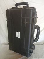 Closed case standing upright showing front, handles and wheels