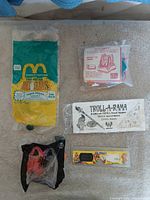 All five sealed promotional toys laid out together
