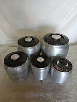 Full set of five aluminum canisters displayed together