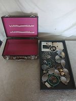 Overall lot view with open case and tray of jewelry