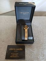 Watch in open presentation box with booklet visible