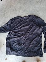 Back view of black American Eagle long sleeve cotton shirt laid flat