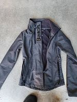 Front view of Bench gray softshell jacket, unzipped to show collar and pockets